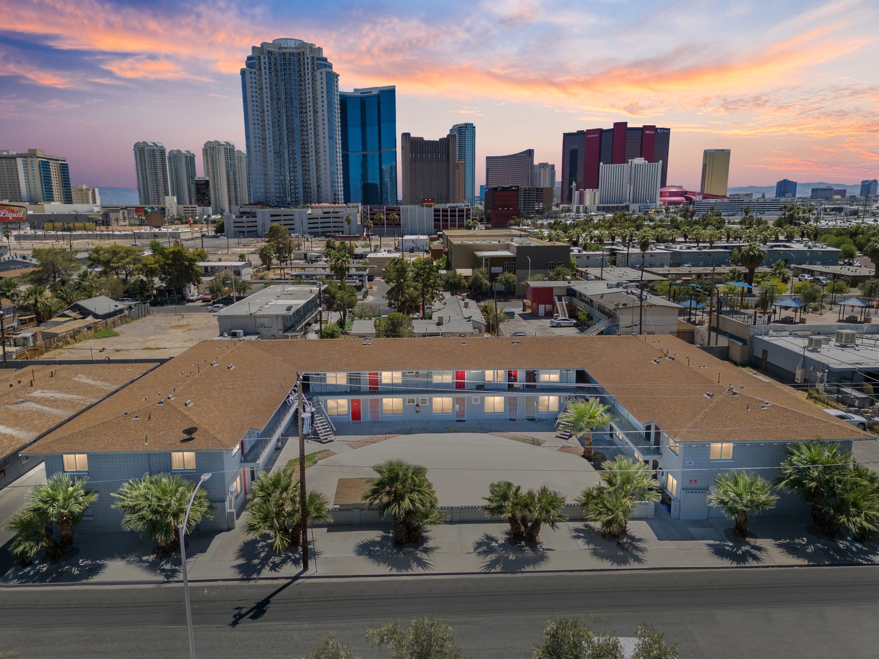 Aerial view of a Lighthouse apartment building in Naked City with the Las Vegas Strip behind it