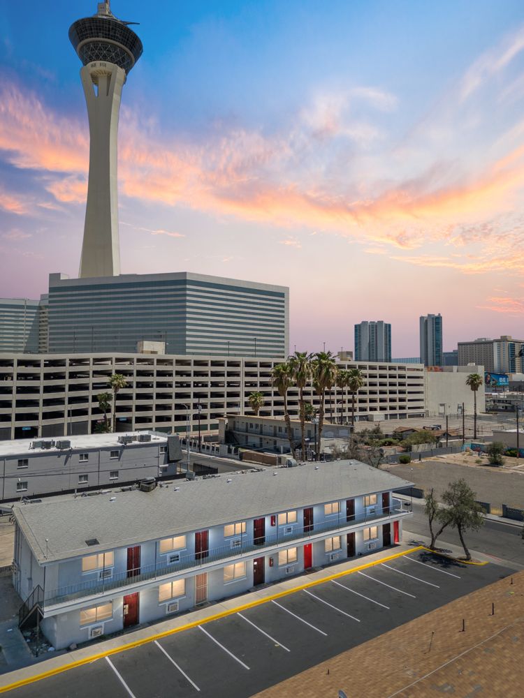 Lighthouse apartment building in Naked City with the Stratosphere tower behind it